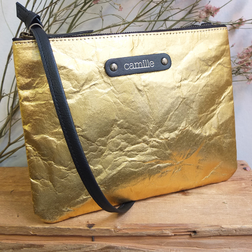 Petit sac pochette en cuir vegan Piñatex doré avec anse amovible.